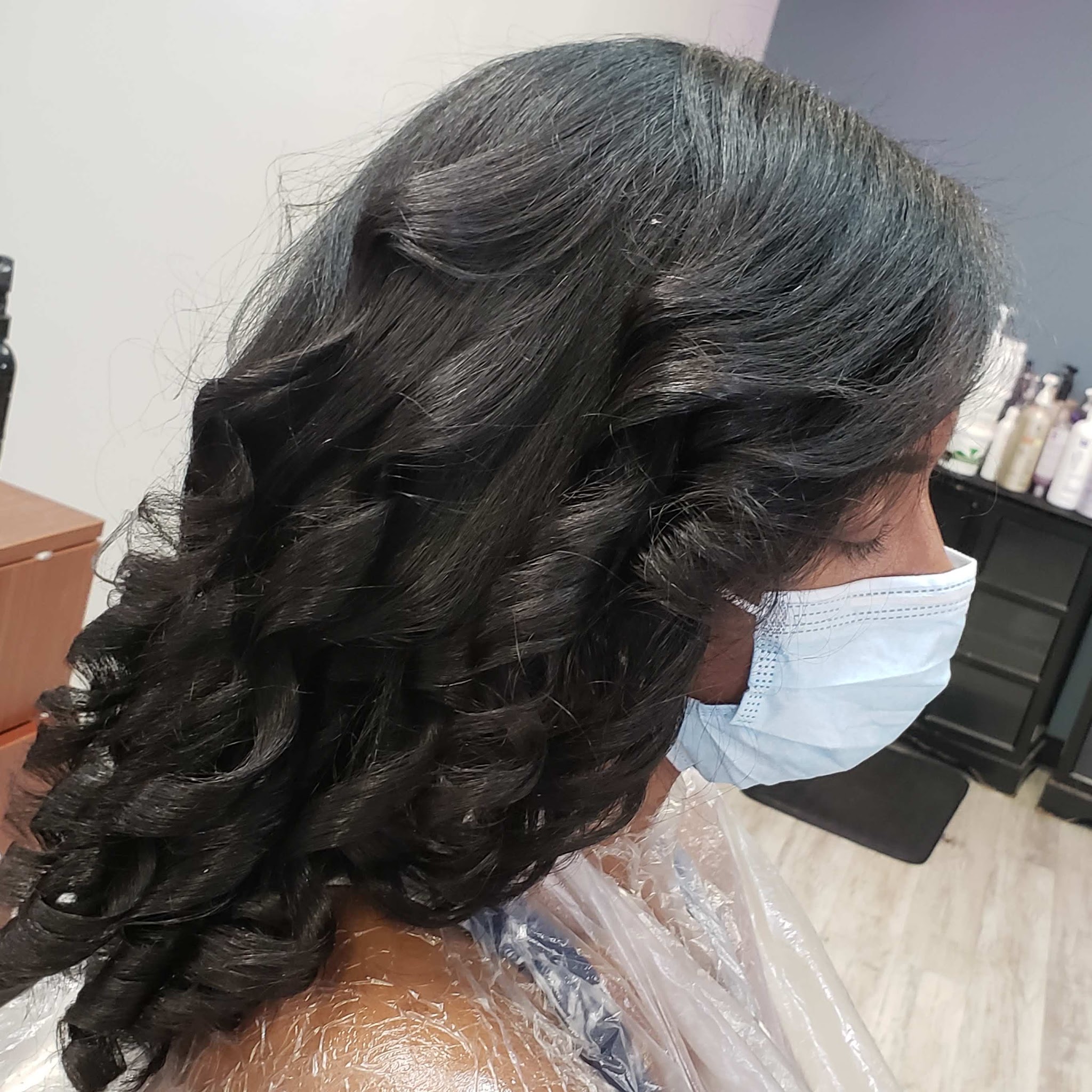 Voluminous dark curls with a glossy finish